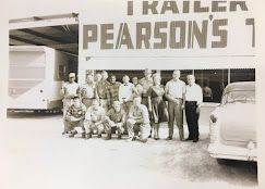 A group of people poses in front of a building