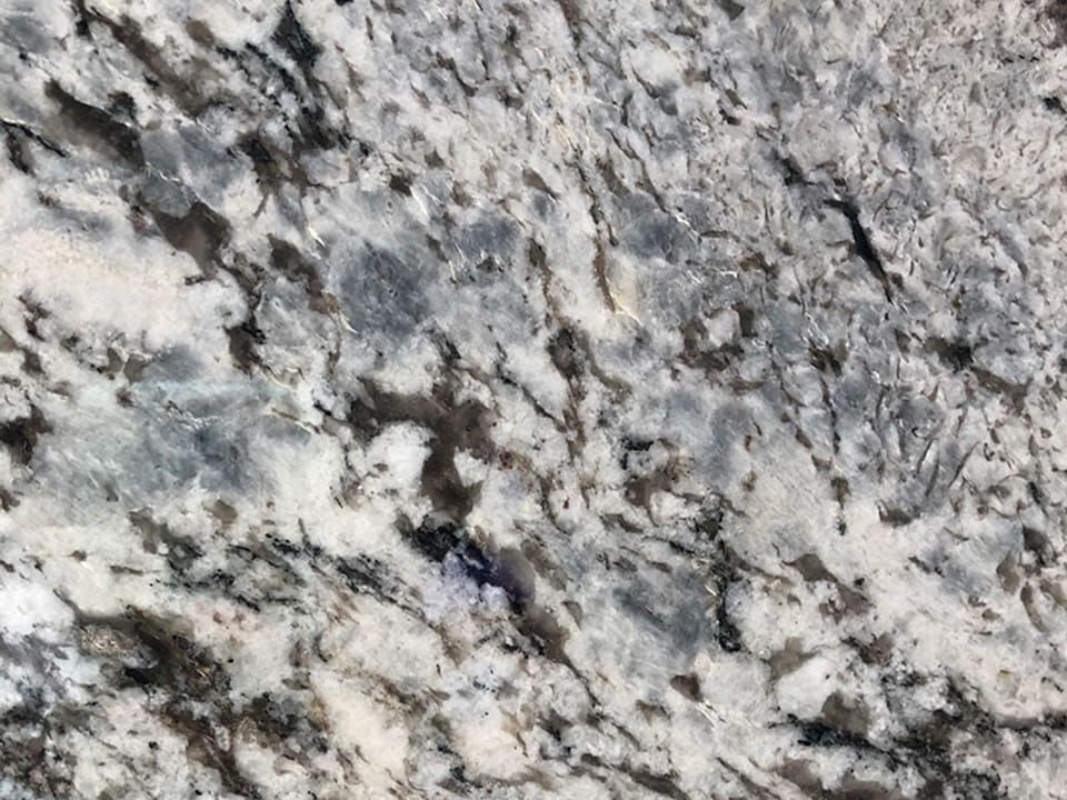 A close up of a white granite counter top