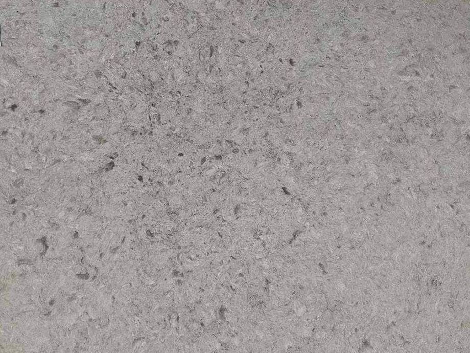 A close up of a gray quartz counter top.