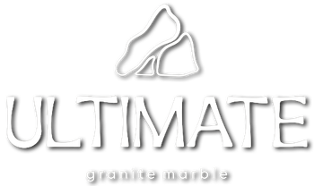 A white logo for ultimate granite marble with a picture of a rock.