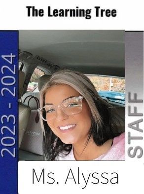 A woman wearing glasses is sitting in the back seat of a car.