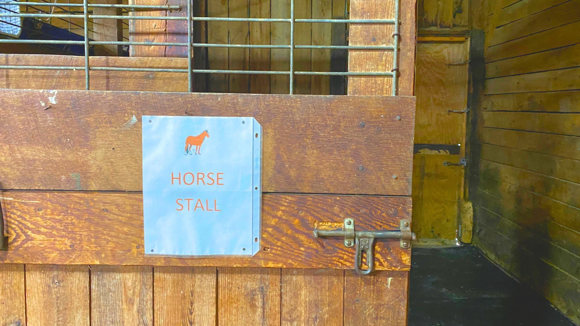 A horse stall with a sign on the door that says horse stall