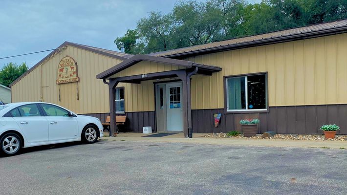 A sign on the side of a building showing West Branch Animal Clinic