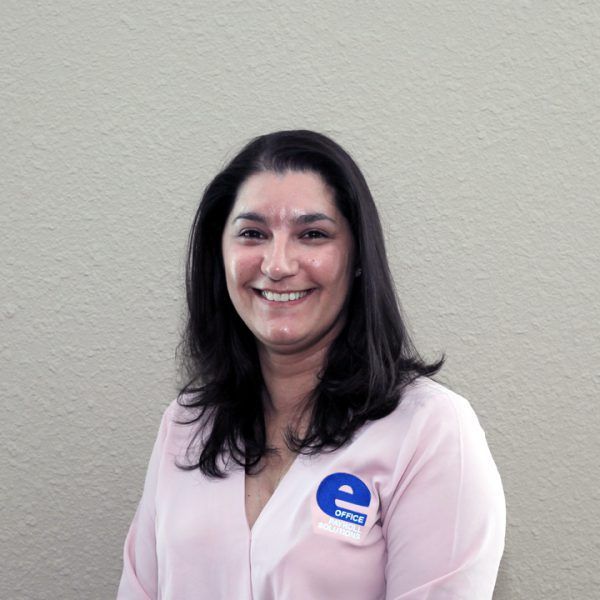 A woman wearing a pink shirt with a blue e on her chest