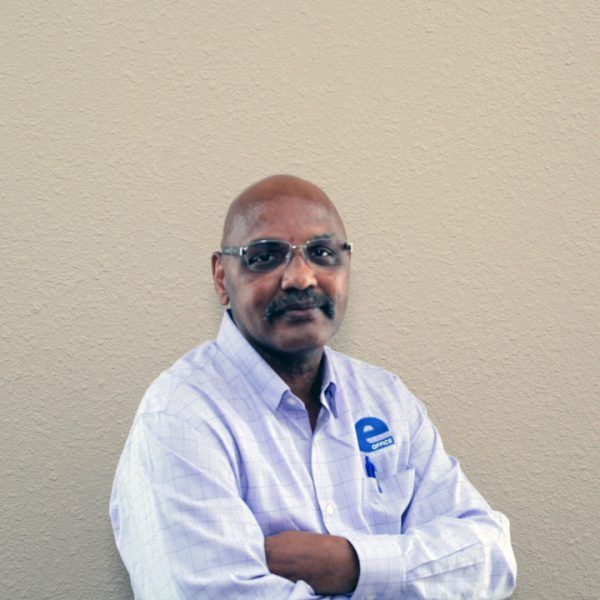 A man wearing glasses and a shirt with the letter p on it