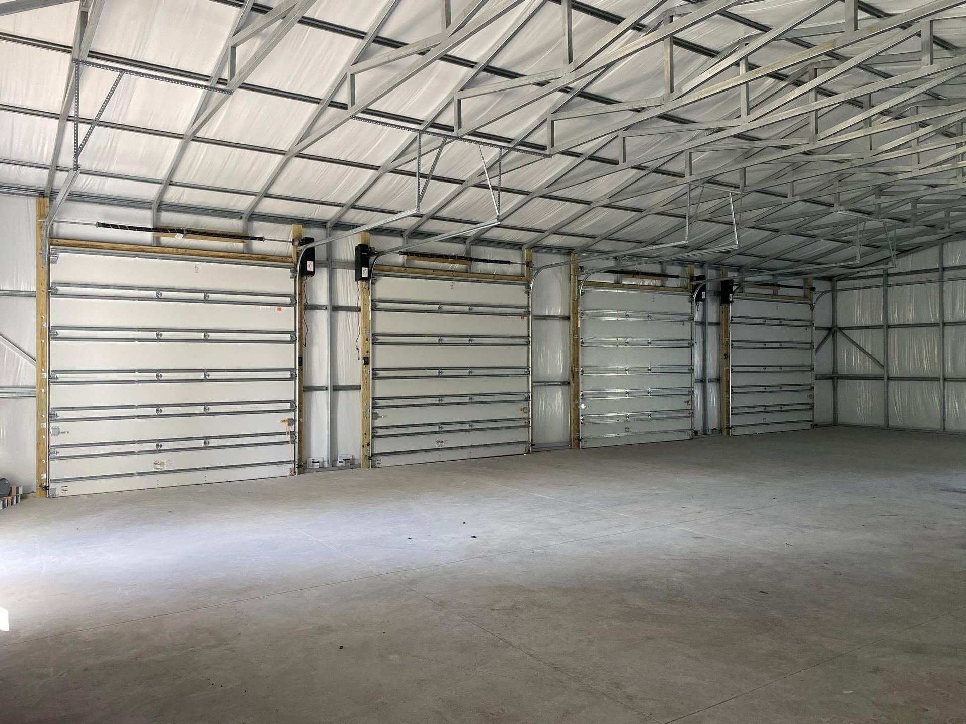 A large empty warehouse with a lot of doors