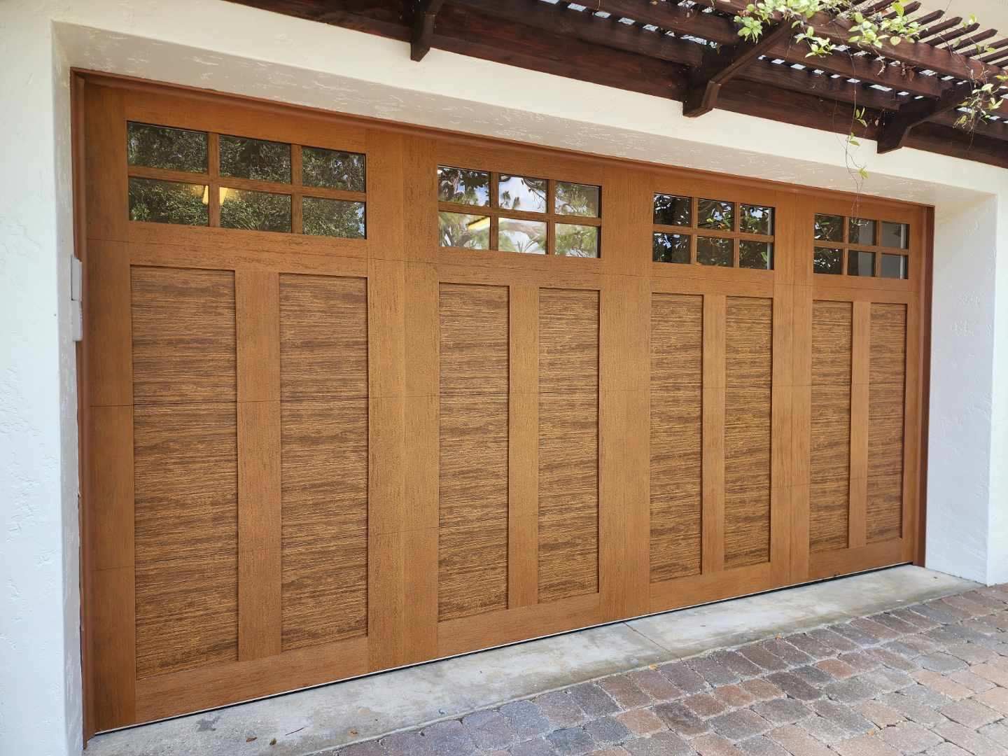 A large wooden garage door with a lot of windows