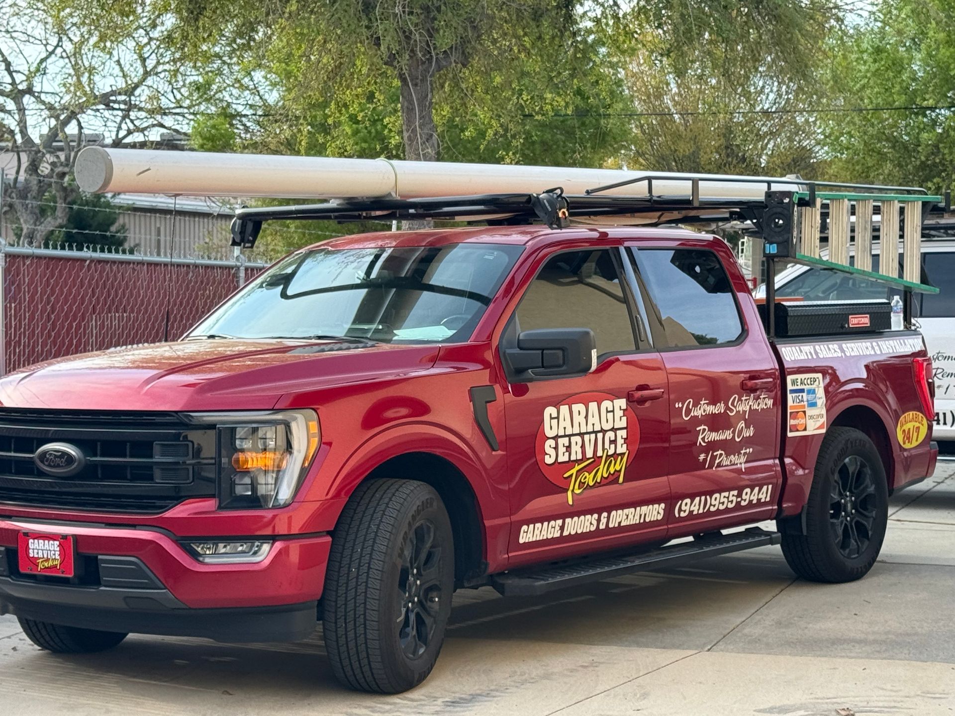 A red ford truck is parked on the side of the road.