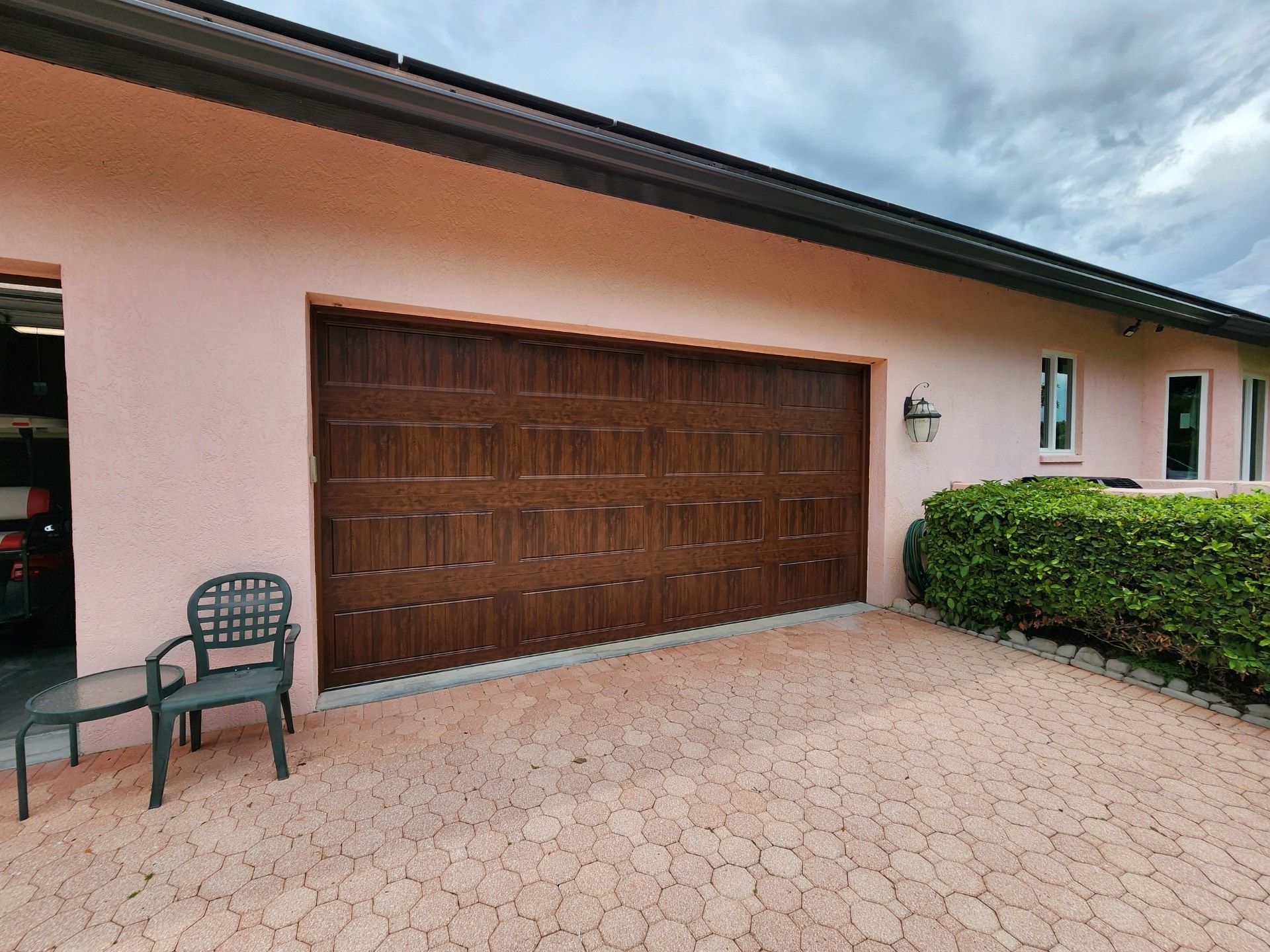 A house with a large garage door and a chair in front of it