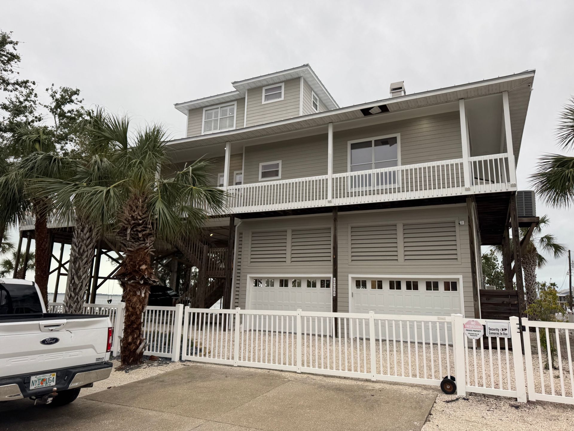 A large house with a white pick up truck parked in front of it.