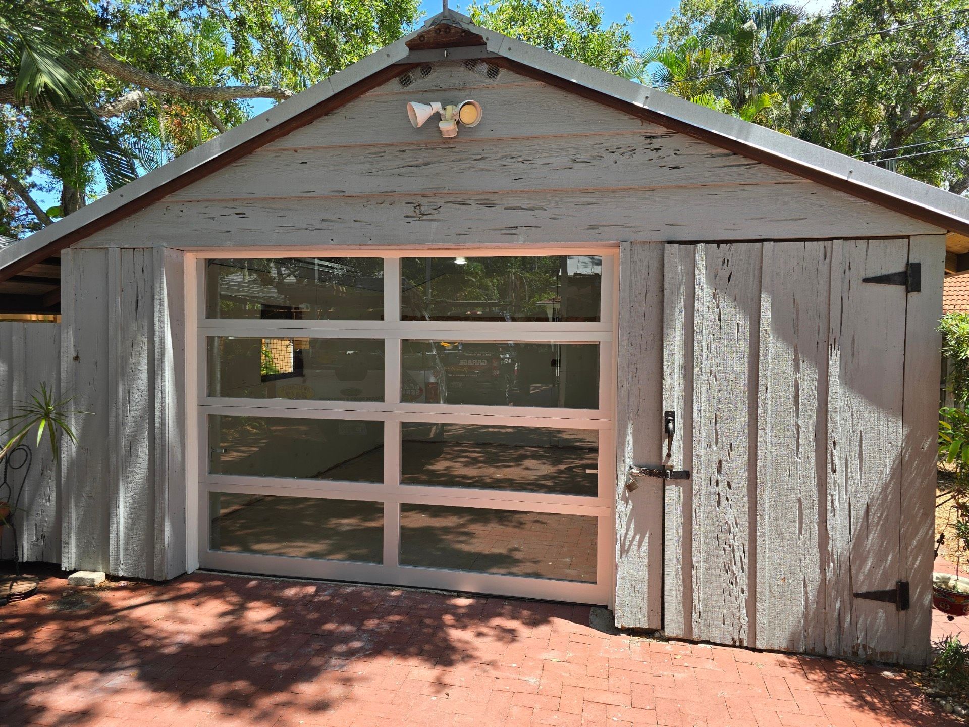 A white garage with a large glass garage door