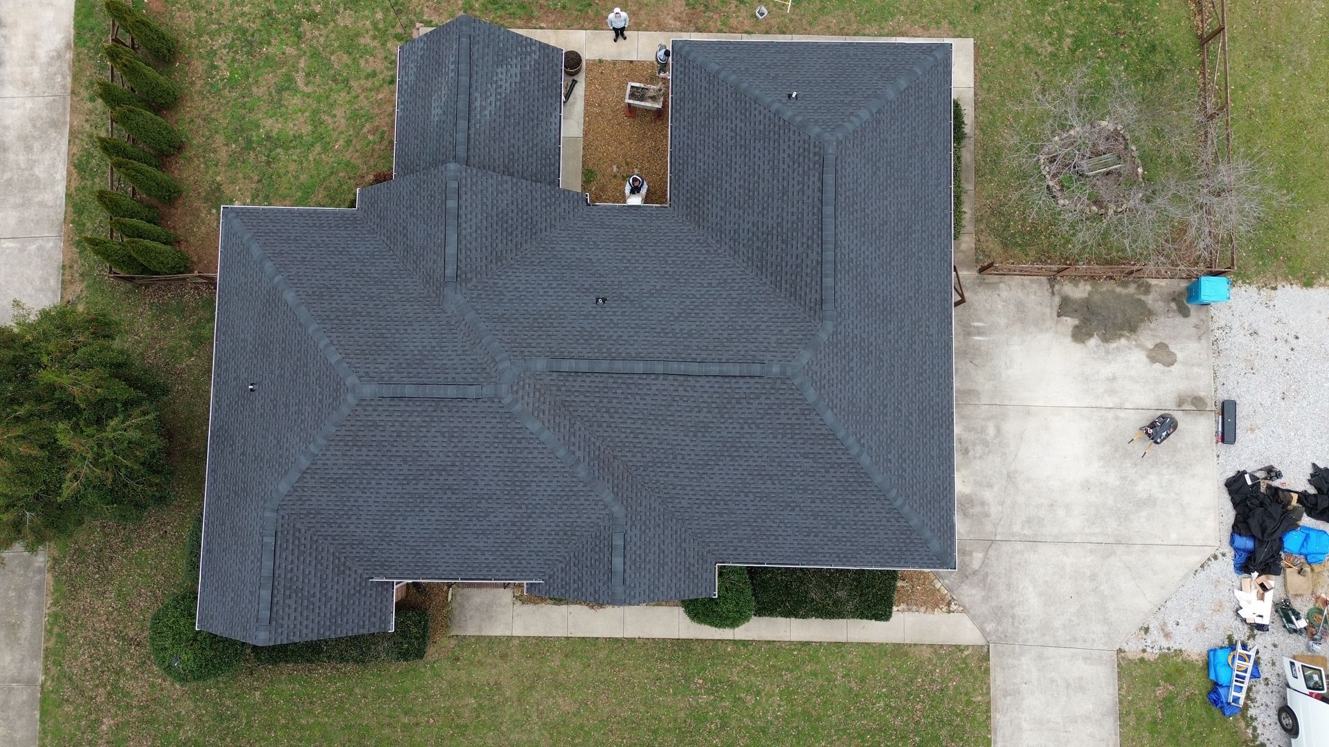 An aerial view of a house with a new roof.