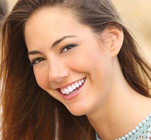 A close up of a woman 's face with a big smile on her face.