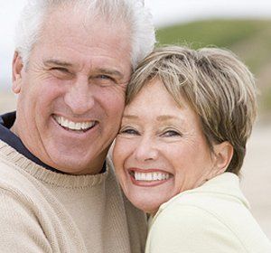 A man and a woman are smiling for the camera.