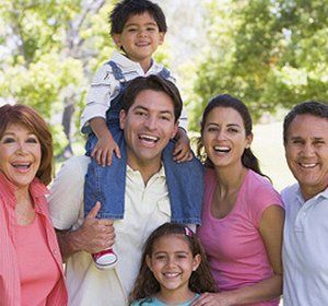 A group of people are posing for a picture in a park.