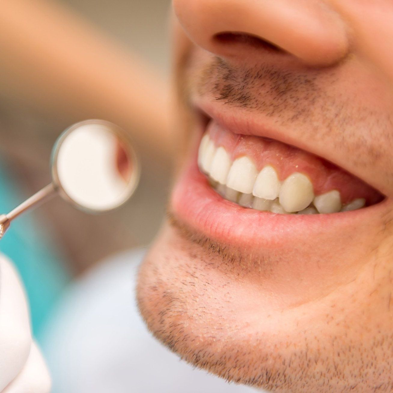 A man is getting his teeth examined by a dentist.