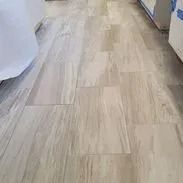 Light-colored rectangular tile flooring in a room.
