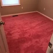 Red carpeted room with a window.