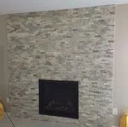 Fireplace with a textured gray brick-like surround.