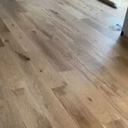 Light-colored hardwood floor with a subtle wood grain pattern.