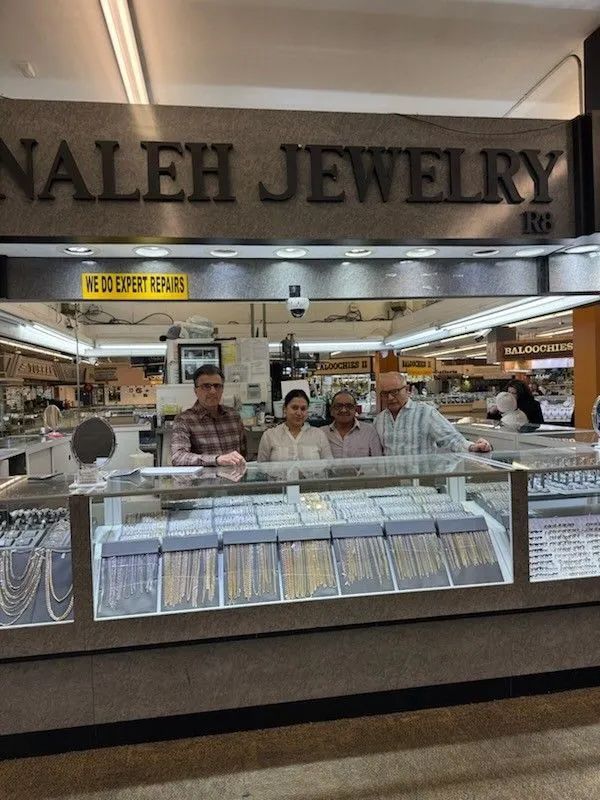 A group of people standing in front of a nalleh jewelry store.