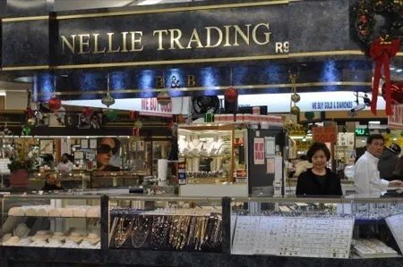 A store called nellie trading has a lot of jewelry on display.