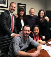 A group of people posing for a picture in an office