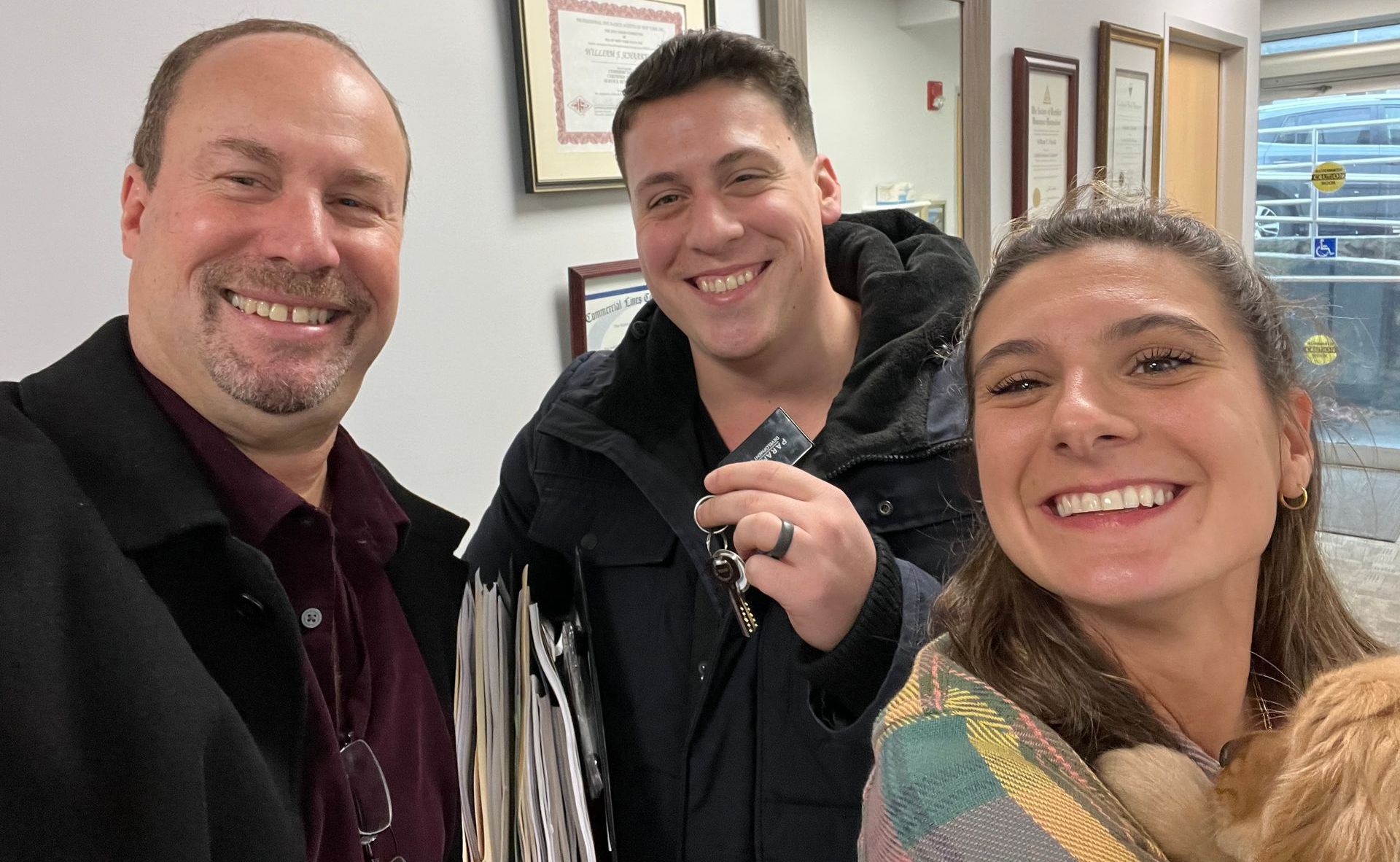 Three people are posing for a picture