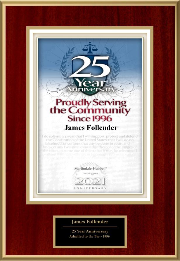 A 25th anniversary certificate is framed in a wooden frame.