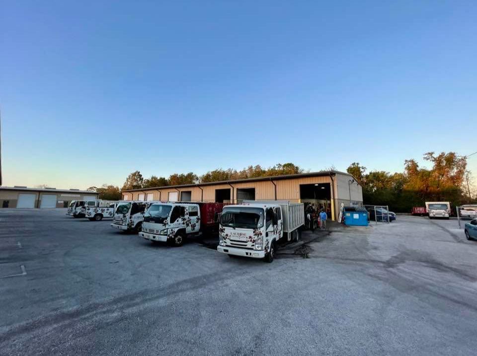 A row of trucks are parked in front of a building.