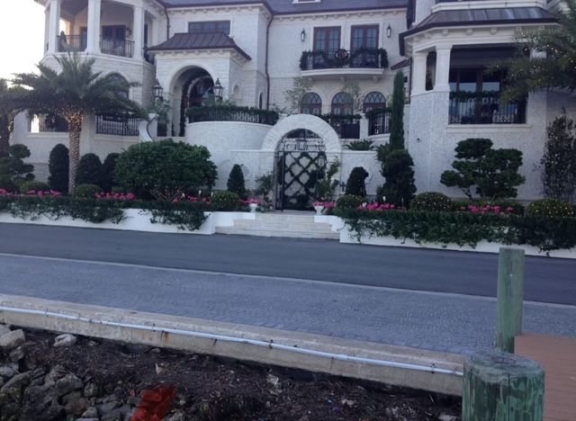 A large white house with a dock in front of it