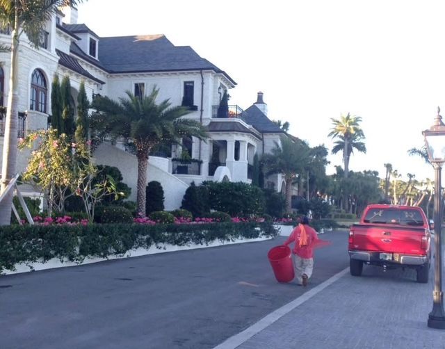 A red truck is parked on the side of the road