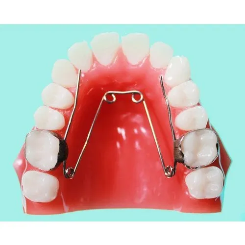 A model of a mouth with teeth and braces on it