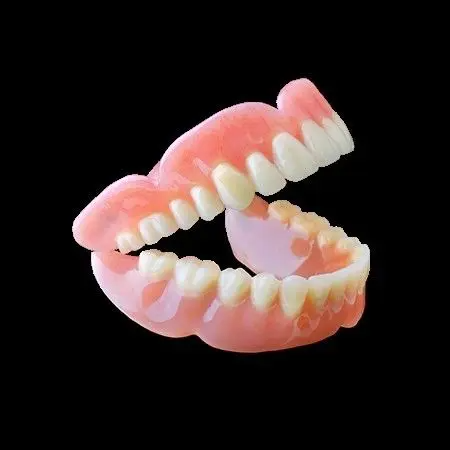 A close up of a denture on a black background