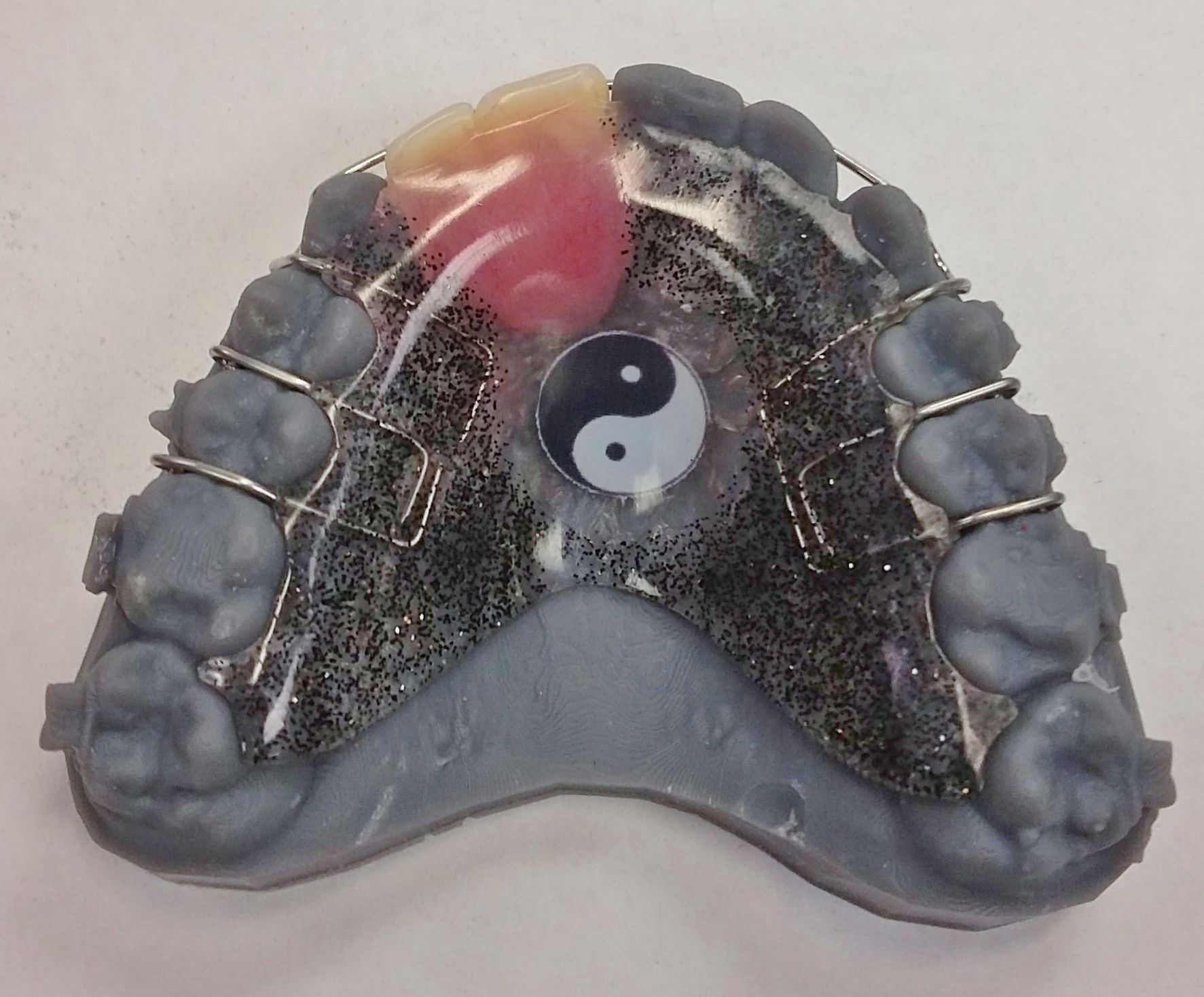 A model of teeth with a yin yang symbol on it