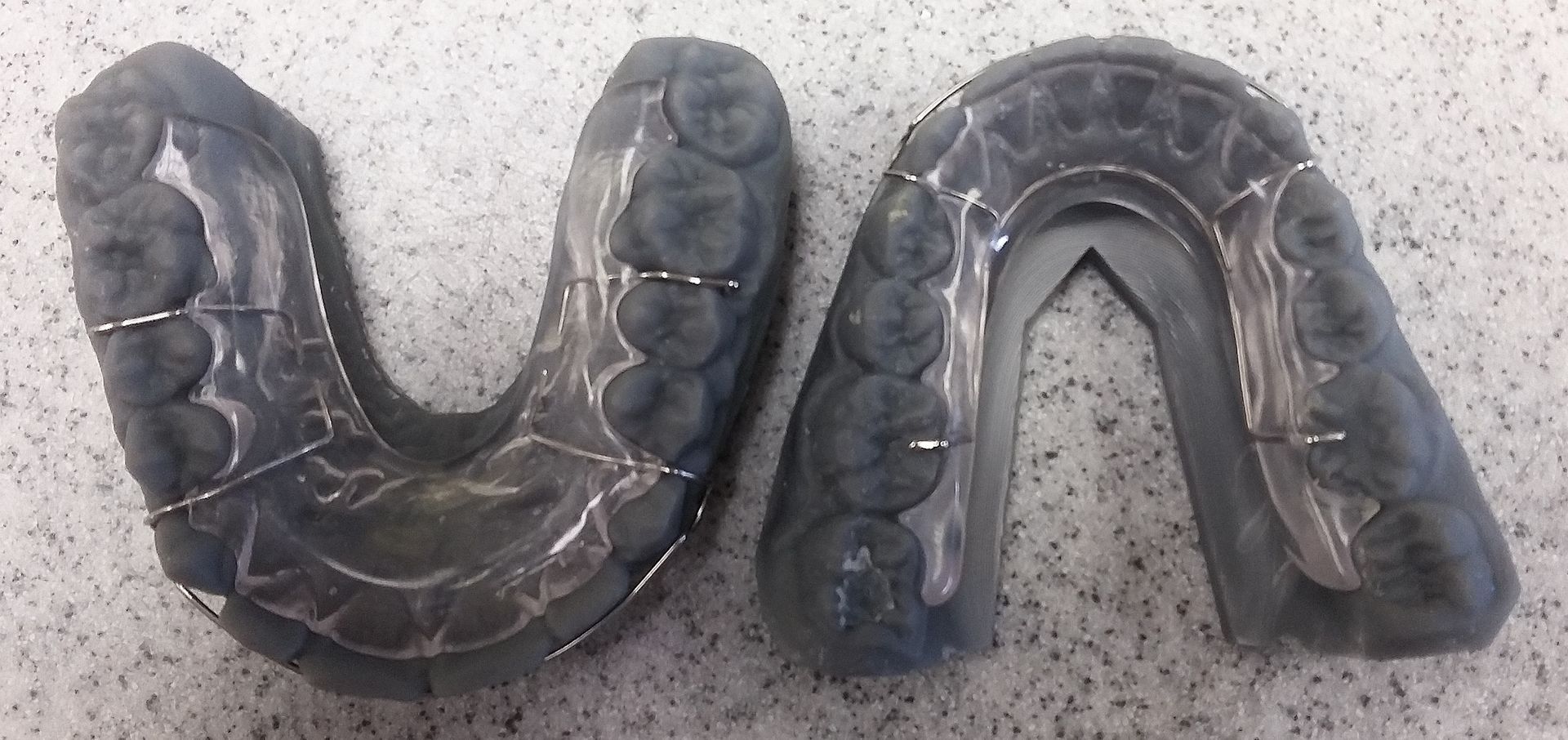 A piece of plastic that looks like a horseshoe is on a table