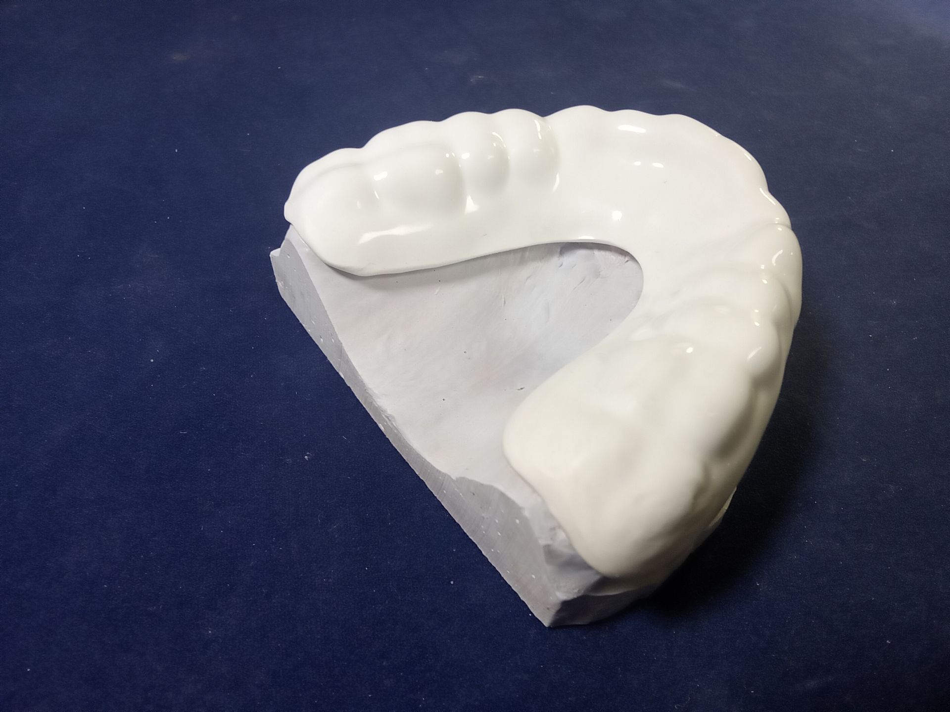 A piece of white foam is sitting on a blue surface