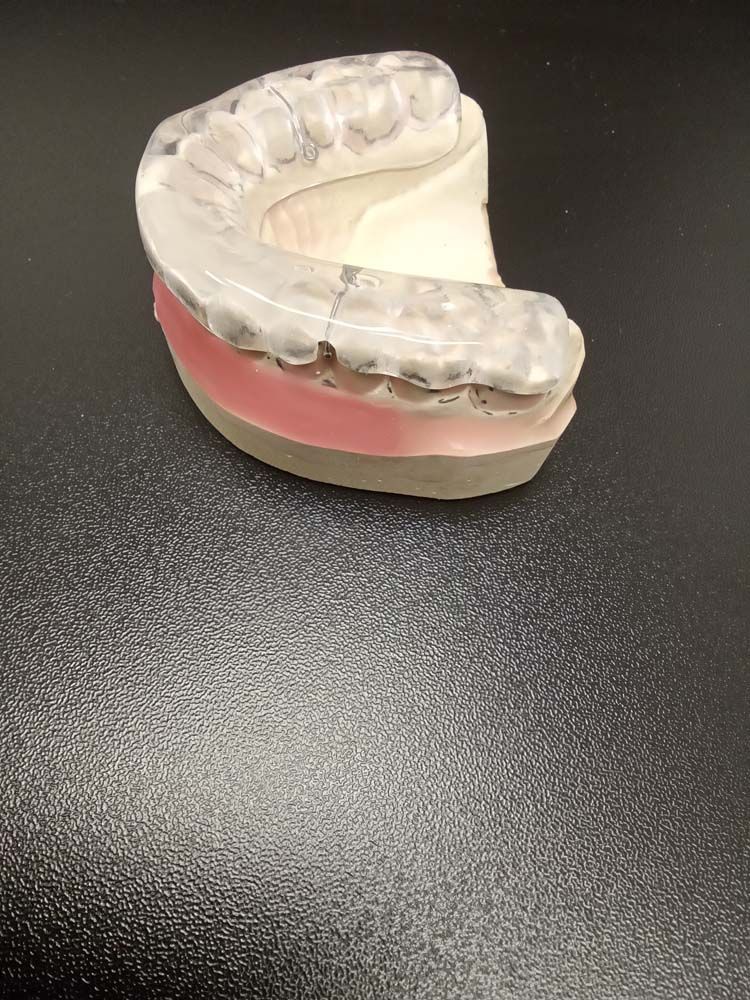 A mouth guard is sitting on top of a black table.
