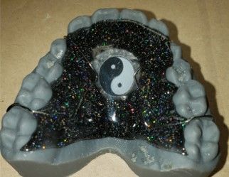 A close up of a dental model with red teeth
