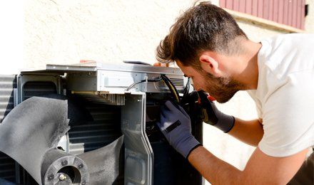 Electrician working on hvac compressor