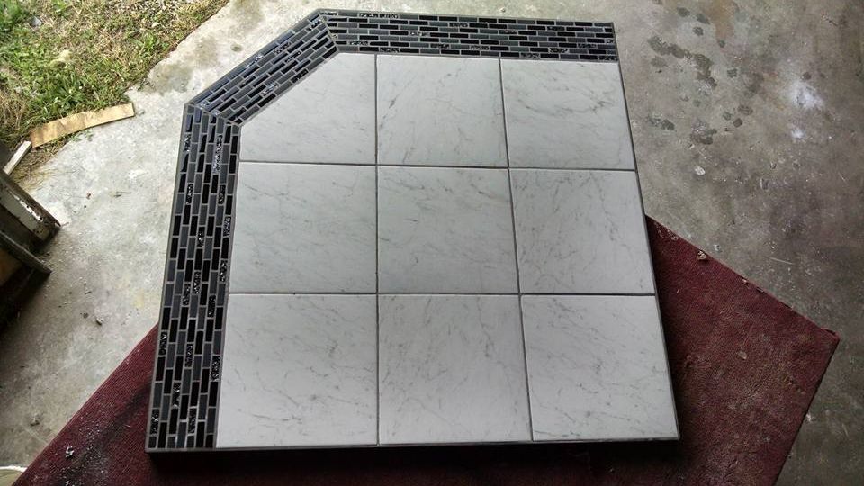 A square tile with a black and white border