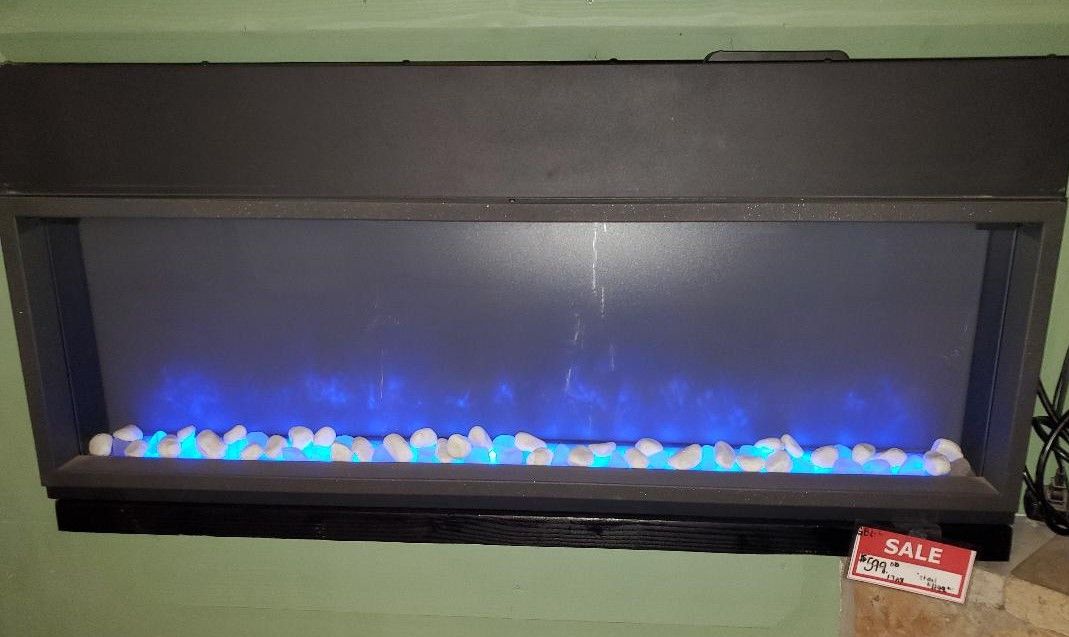 A fireplace with blue lights on it is hanging on a wall.