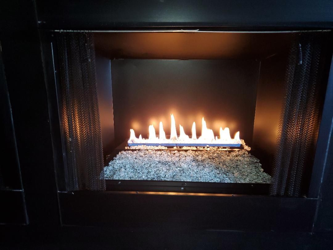 A fireplace with a lot of flames coming out of it.