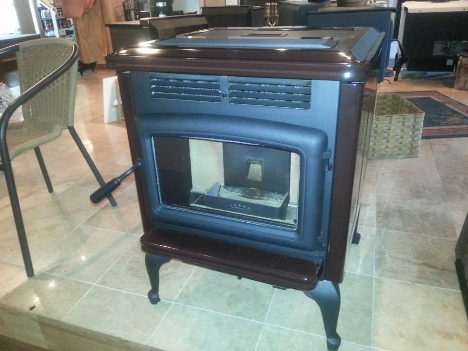 A wood stove is sitting on a tiled floor in a living room