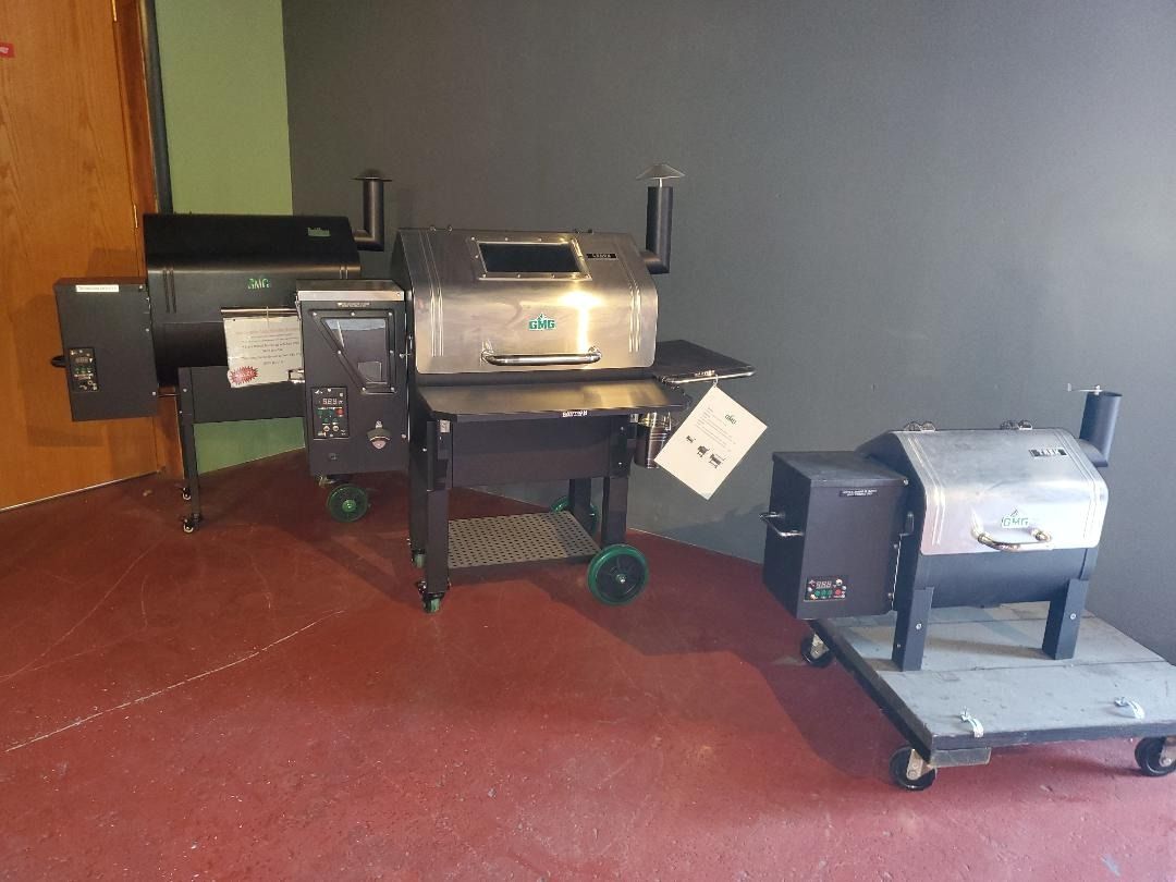 Two grills are sitting on a cart in a room.