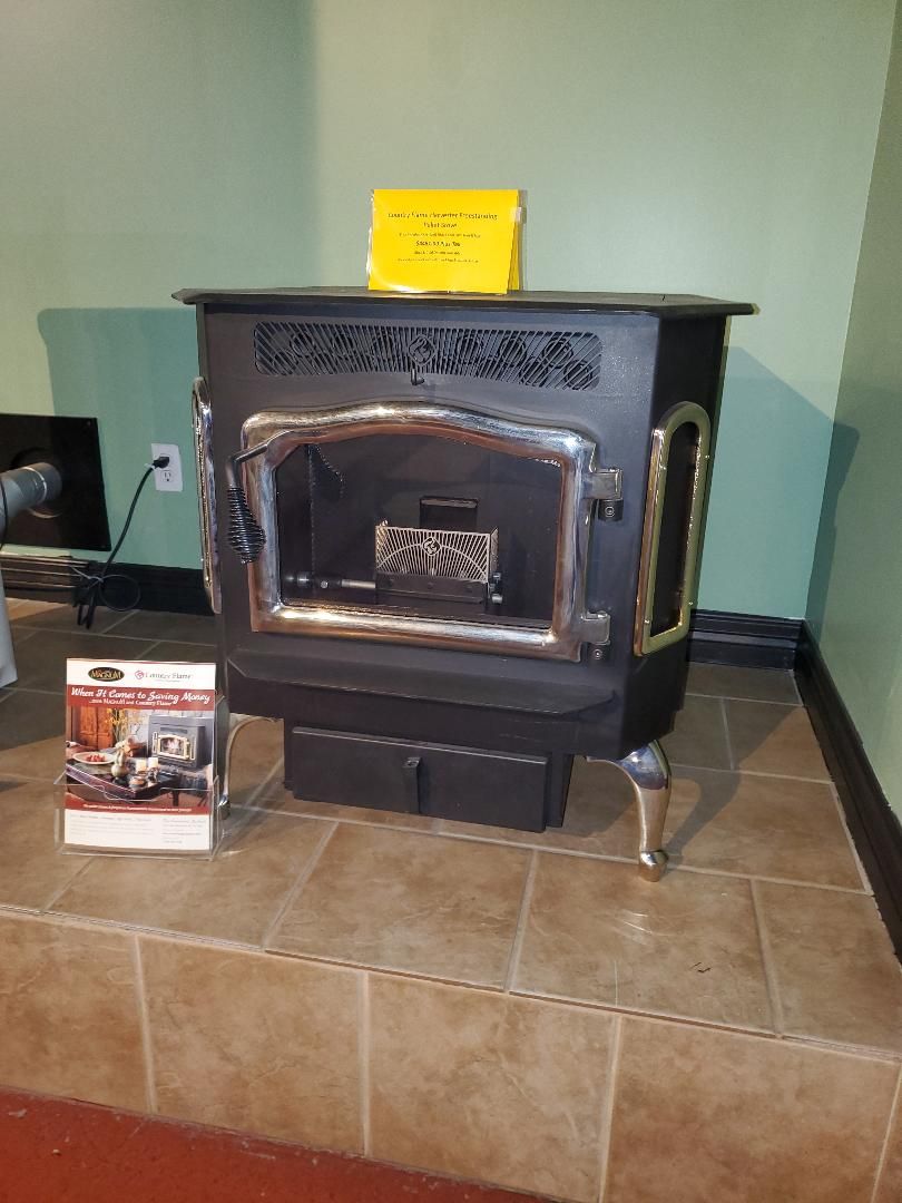 A wood stove is sitting on a tiled floor in a room.