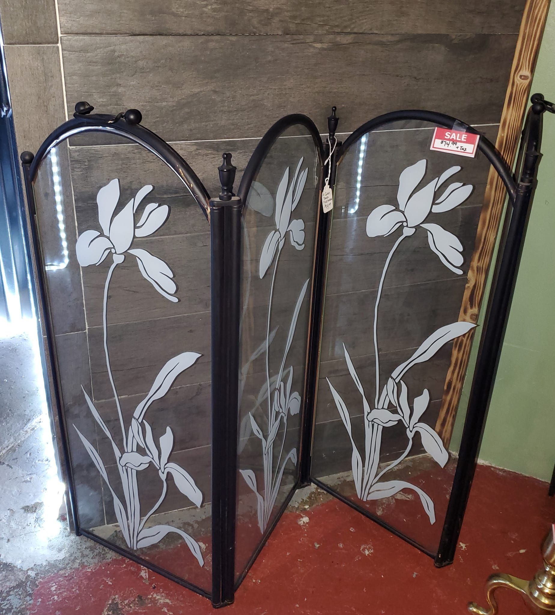 A fireplace screen with a dragonfly design on it