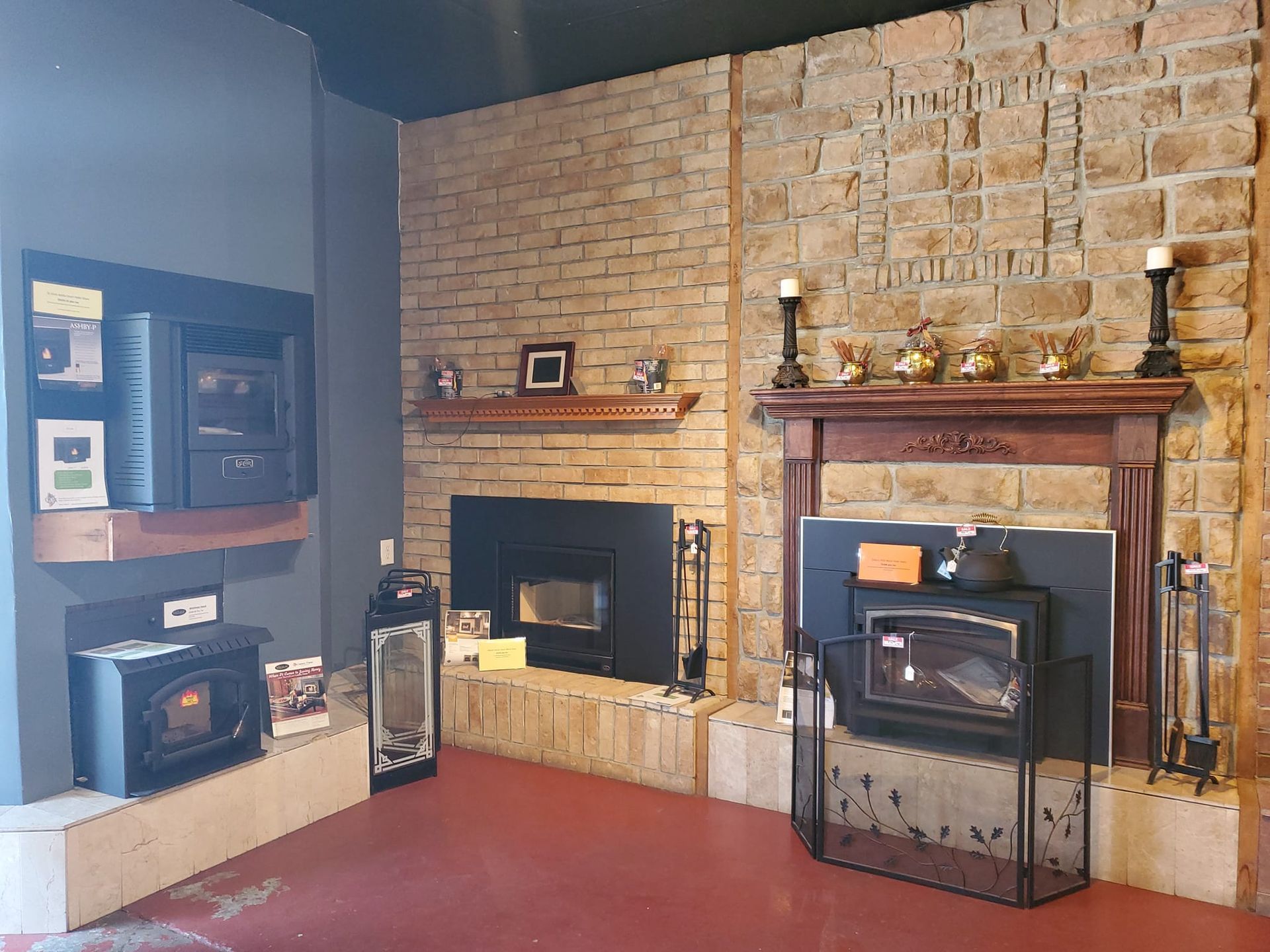 A living room with a fireplace and a brick wall.