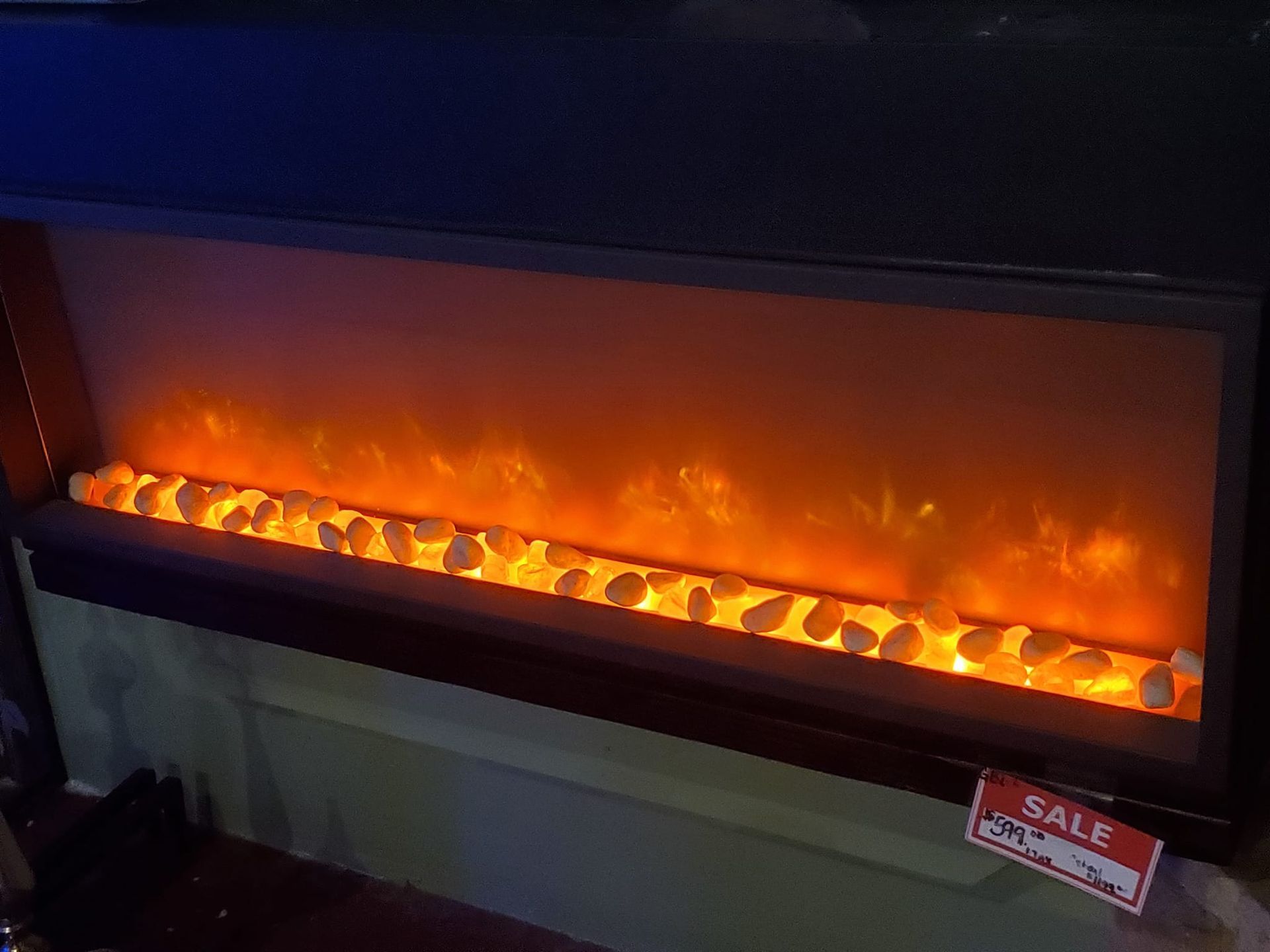 A fireplace with a sign that says sale on it.