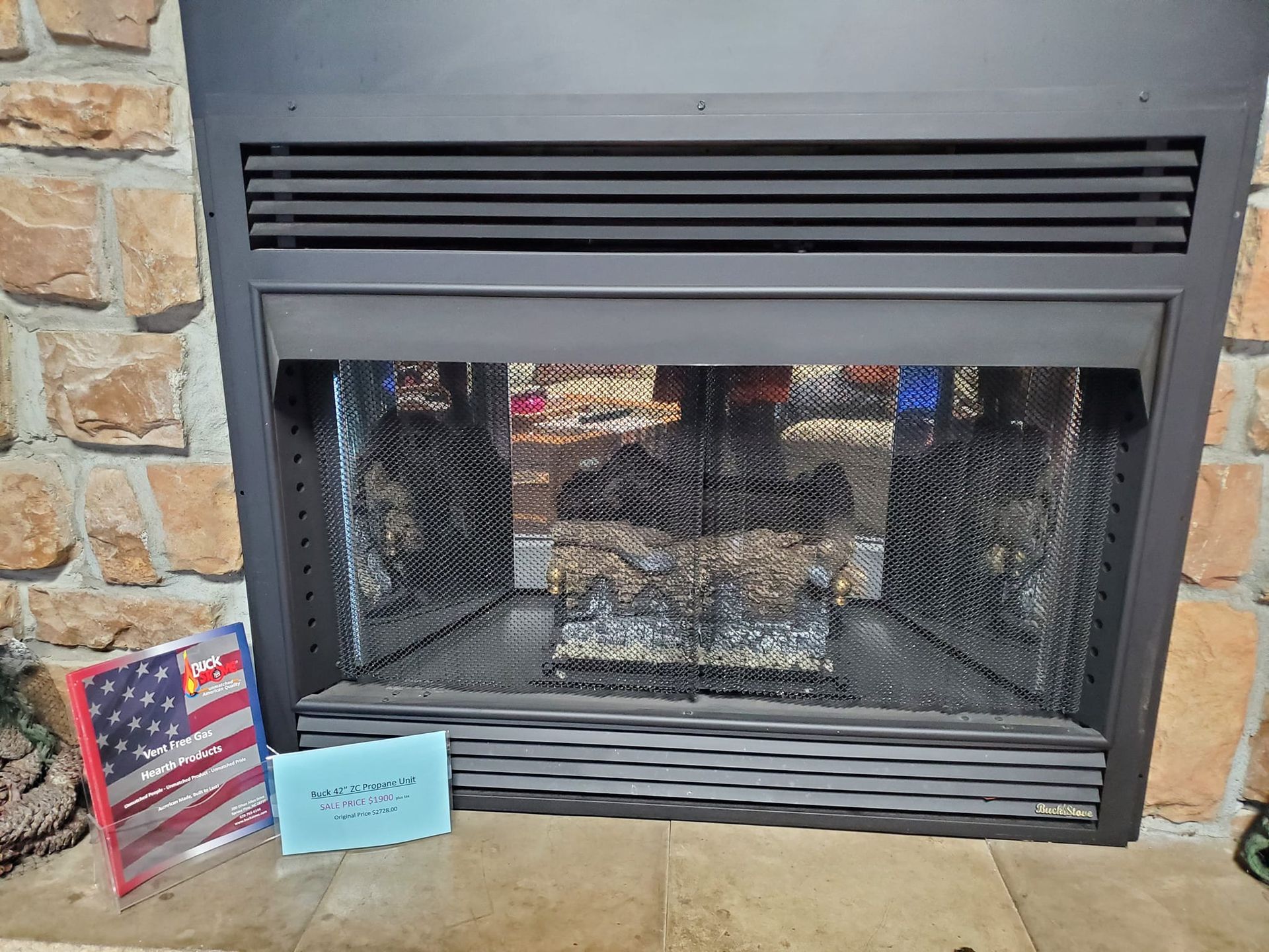 A fireplace with an american flag next to it.